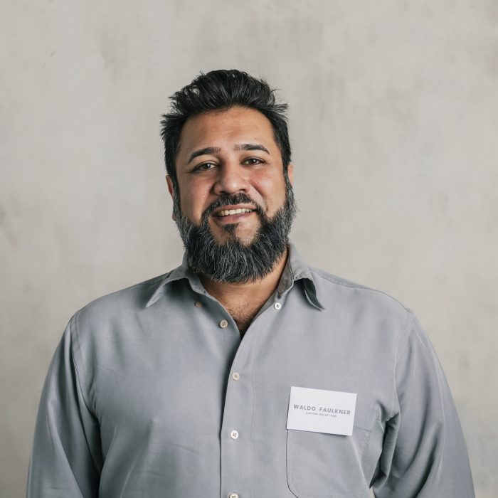 happy-indian-salesman-wearing-a-name-tag.jpg